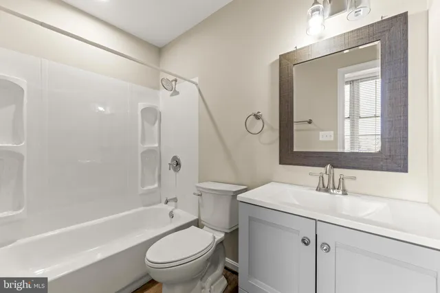 a bathroom with a sink toilet tub and shower