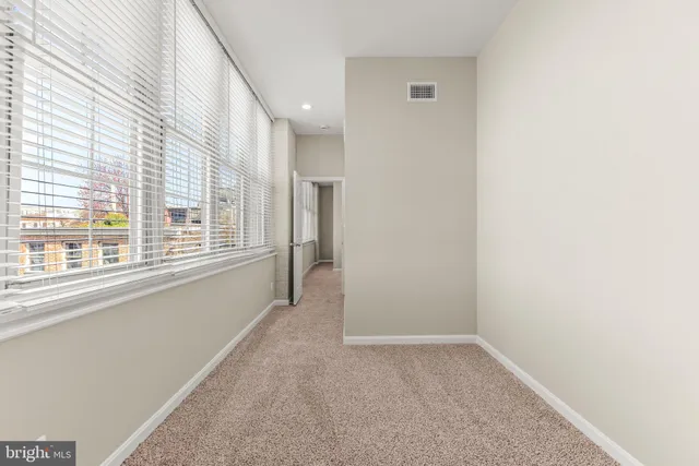 a view of a kitchen with a sink and a refrigerator