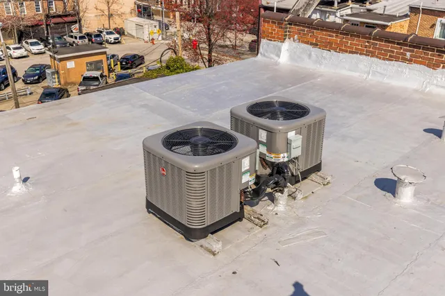 a view of a hallway with wooden floor and entryway