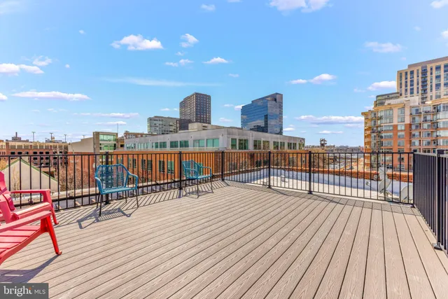 a city street lined with parked cars and buildings