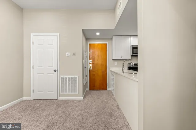 a view of a refrigerator in kitchen and wooden floor
