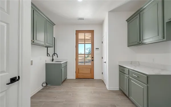 a room with cabinets and washer