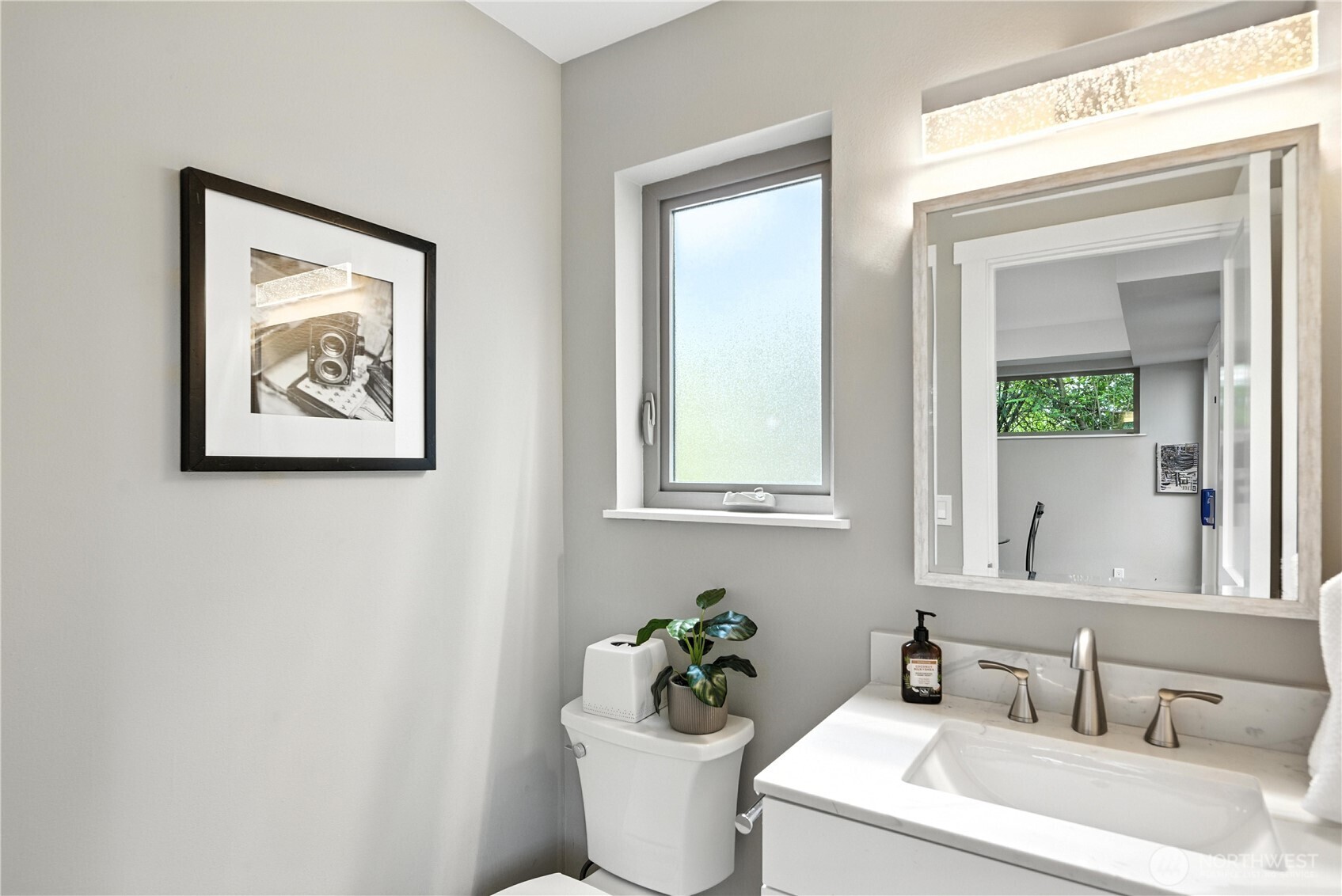8221 South 121st Street Seattle, WA 98178 - Photo 13 of 37 a bathroom with a toilet a sink and mirror