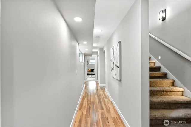 a view of a hallway with wooden floor