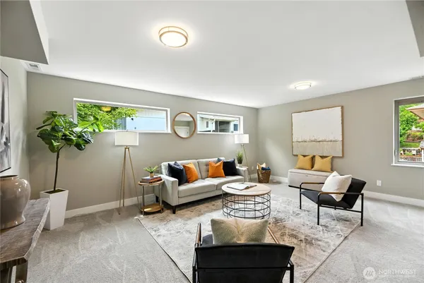 a living room with furniture potted plant and a window