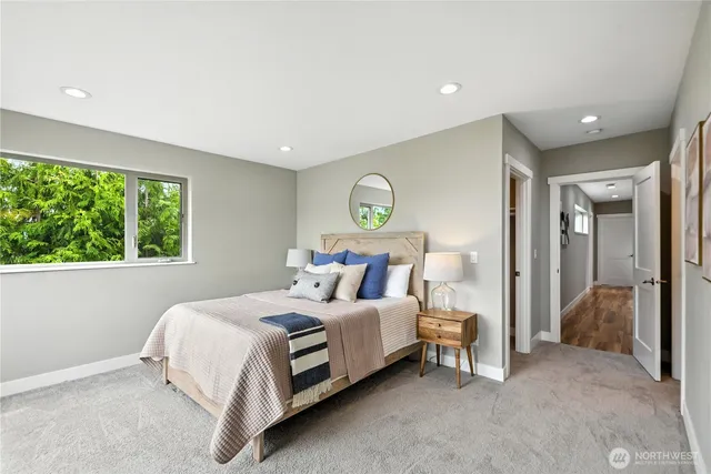 a bedroom with bed and a large window