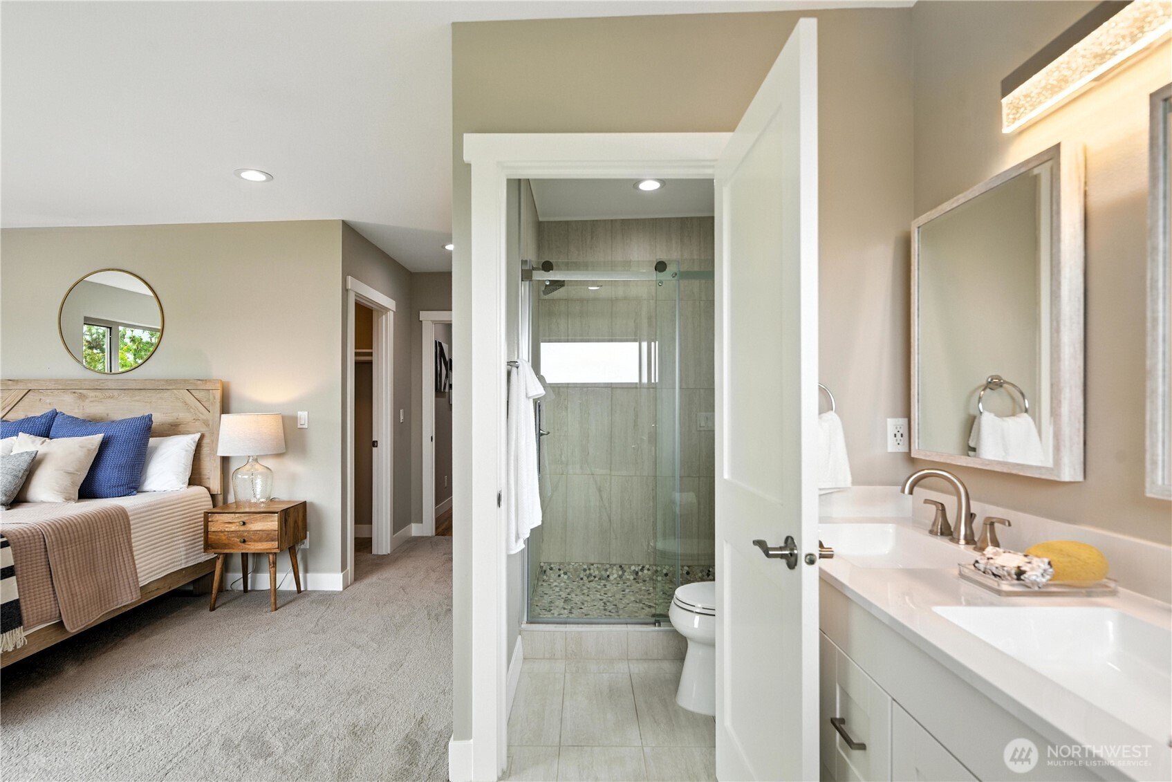 8221 South 121st Street Seattle, WA 98178 - Photo 27 of 37 a en suite bathroom with a double vanity sink a mirror and a shower