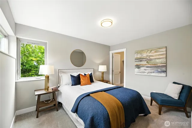 a bedroom with a bed and a large window