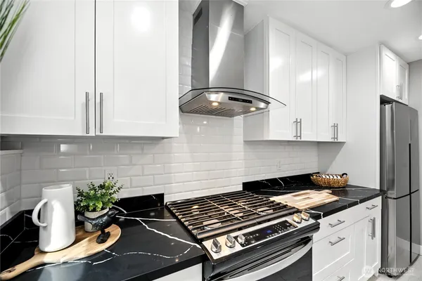 a kitchen with a stove and a refrigerator