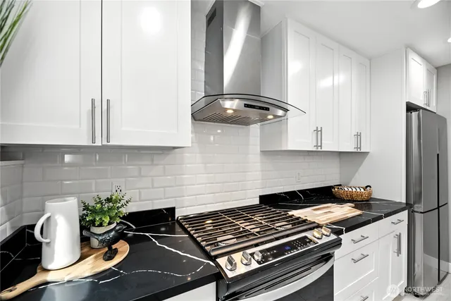 a kitchen with a stove and a refrigerator