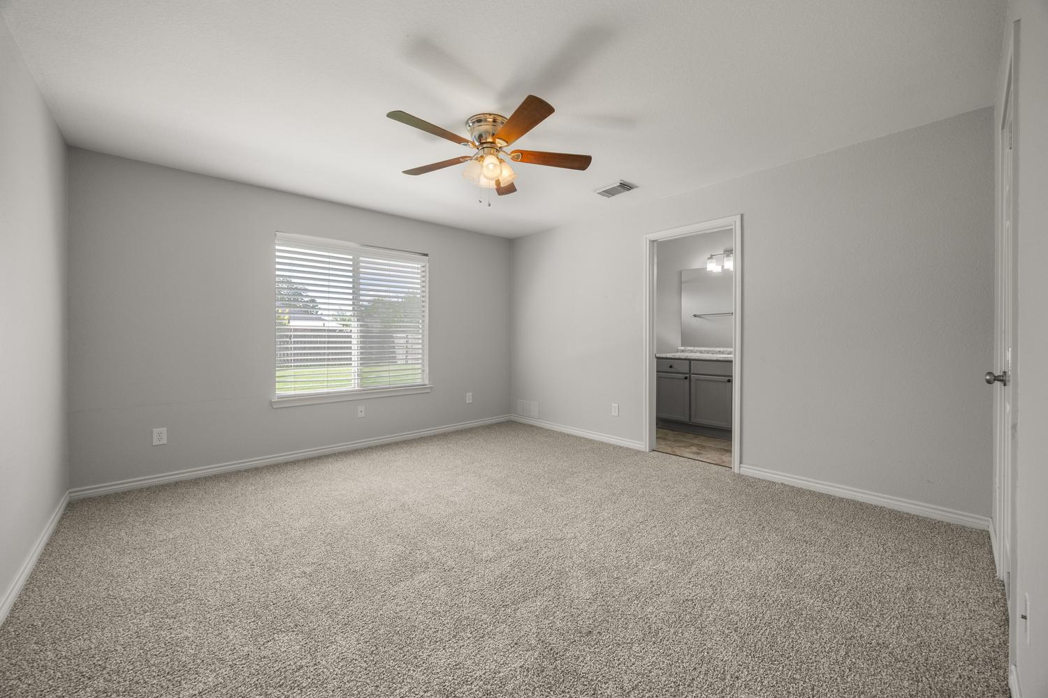 521 Britni Loop Kyle, TX 78640 - Photo 10 of 23 an empty room with windows and fan