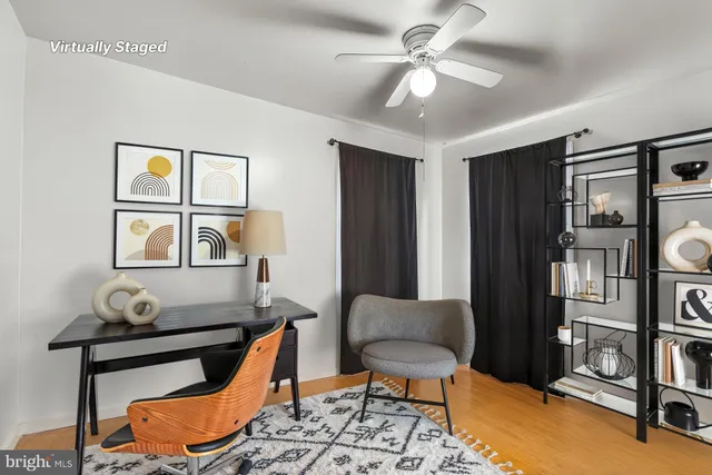 a living room with furniture a rug and a window