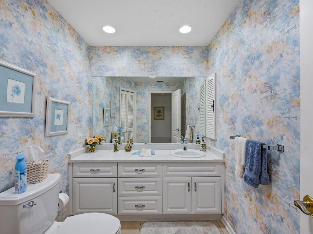 314 Torrey Pines Point Naples, FL 34113 - Photo 15 of 21 a bathroom with double vanity sink a mirror and a toilet