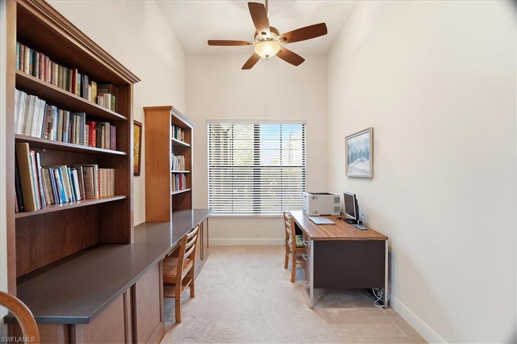 5149 Roma Street Ave Maria, FL 34142 - Photo 21 of 50 a room with furniture book shelf and a window