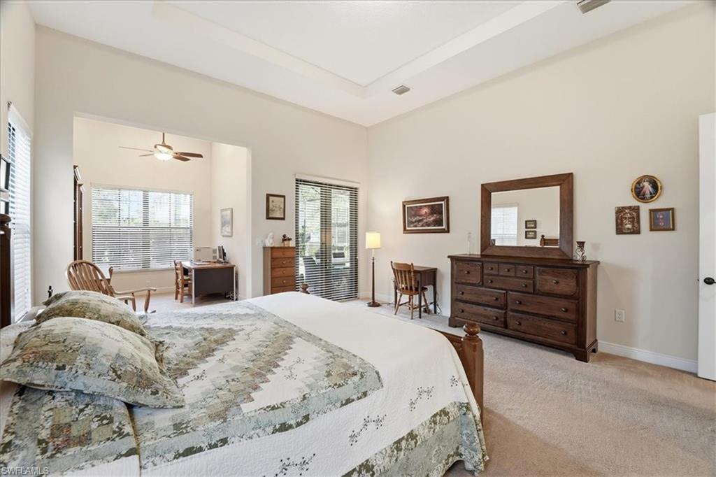 5149 Roma Street Ave Maria, FL 34142 - Photo 22 of 50 a large bedroom with a bed and wooden floor