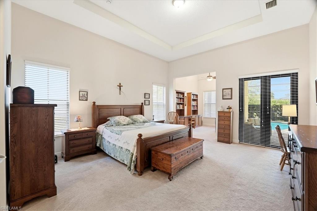 5149 Roma Street Ave Maria, FL 34142 - Photo 23 of 50 a spacious bedroom with a bed and large window