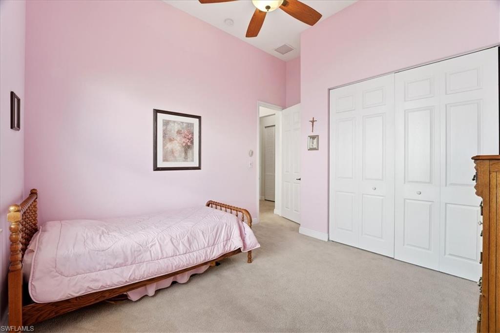 5149 Roma Street Ave Maria, FL 34142 - Photo 28 of 50 a bedroom with a bed and a ceiling fan