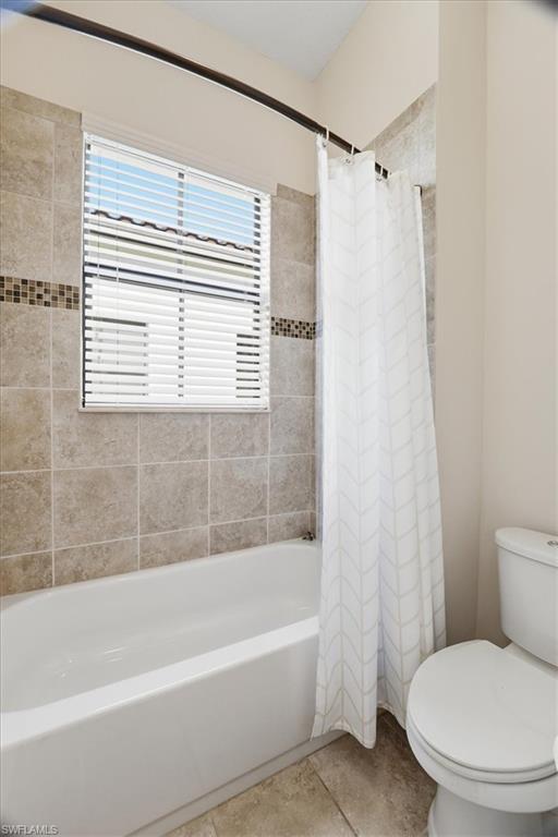 5149 Roma Street Ave Maria, FL 34142 - Photo 31 of 50 a white toilet sitting next to a bath tub