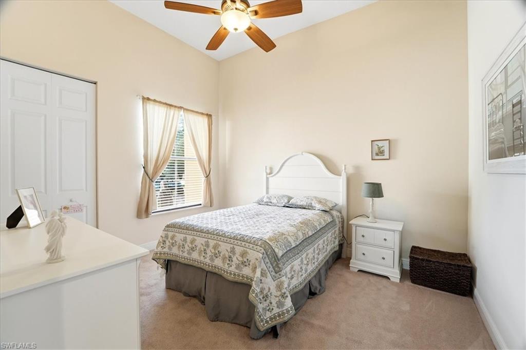 5149 Roma Street Ave Maria, FL 34142 - Photo 34 of 50 a bedroom with a bed and a chandelier