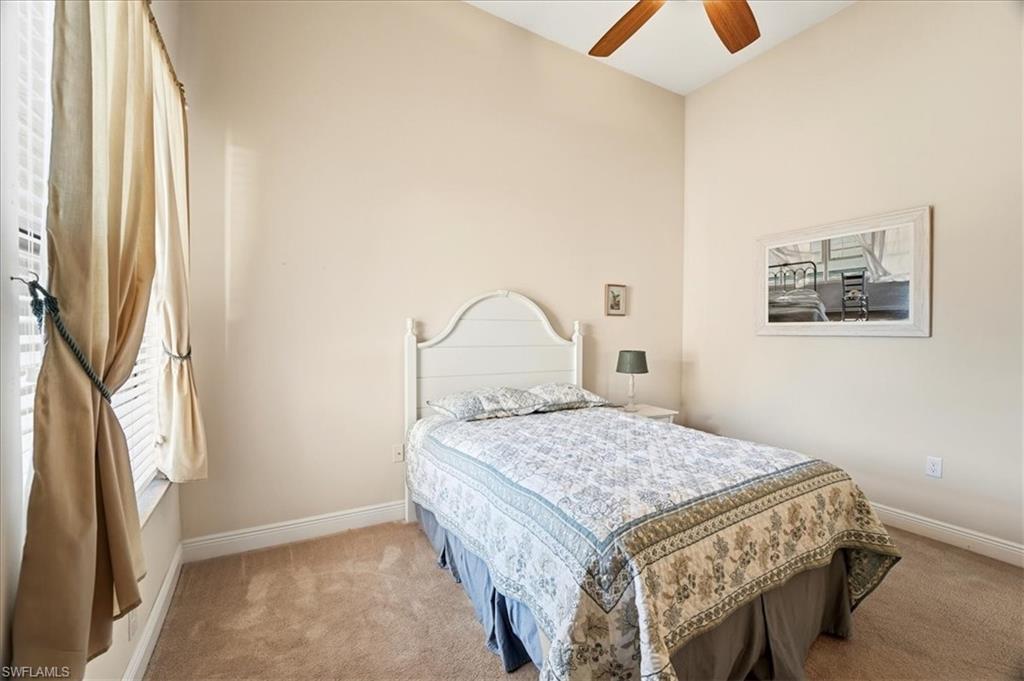 5149 Roma Street Ave Maria, FL 34142 - Photo 35 of 50 a bedroom with a bed and a dresser next to a window