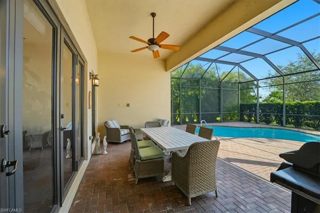 a view of a patio with a table chairs and a backyard