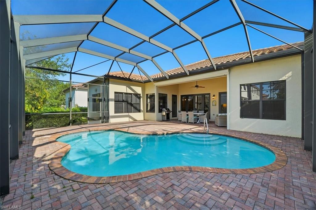 5149 Roma Street Ave Maria, FL 34142 - Photo 40 of 50 a view of a swimming pool in the backyard of a house