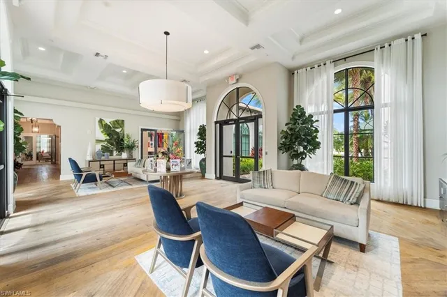 a living room with furniture a chandelier and a dining table