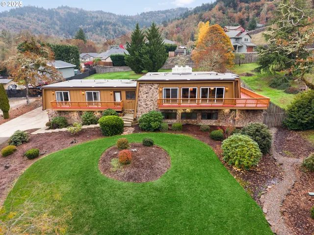a front view of a house with a garden