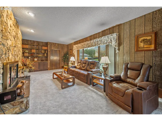 a living room with furniture a rug and a flat screen tv