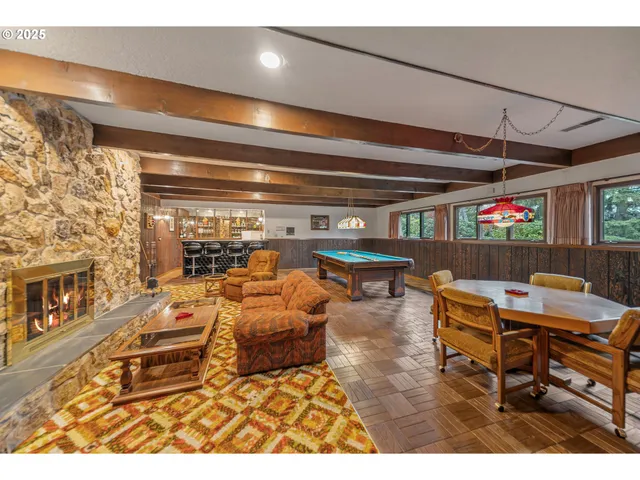 a room with pool table and large windows