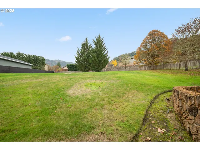 an aerial view of a house with an outdoor space and seating