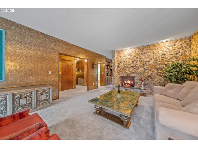 a living room with furniture pool table and a large window
