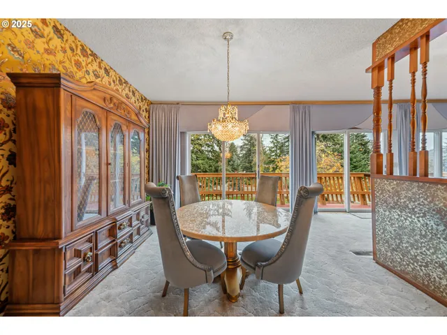 a dining room with furniture a chandelier and wooden floor