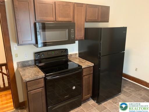 1030 Center Street, Unit 2 Bethlehem, PA 18018 - Photo 2 of 13 a kitchen with a refrigerator and a stove top oven