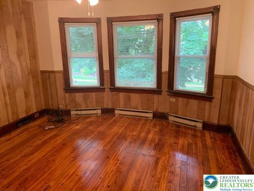 1030 Center Street, Unit 2 Bethlehem, PA 18018 - Photo 6 of 13 an empty room with wooden floor and windows