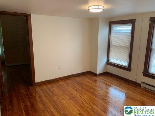 1030 Center Street, Unit 2 Bethlehem, PA 18018 - Photo 7 of 13 an empty room with wooden floor and windows