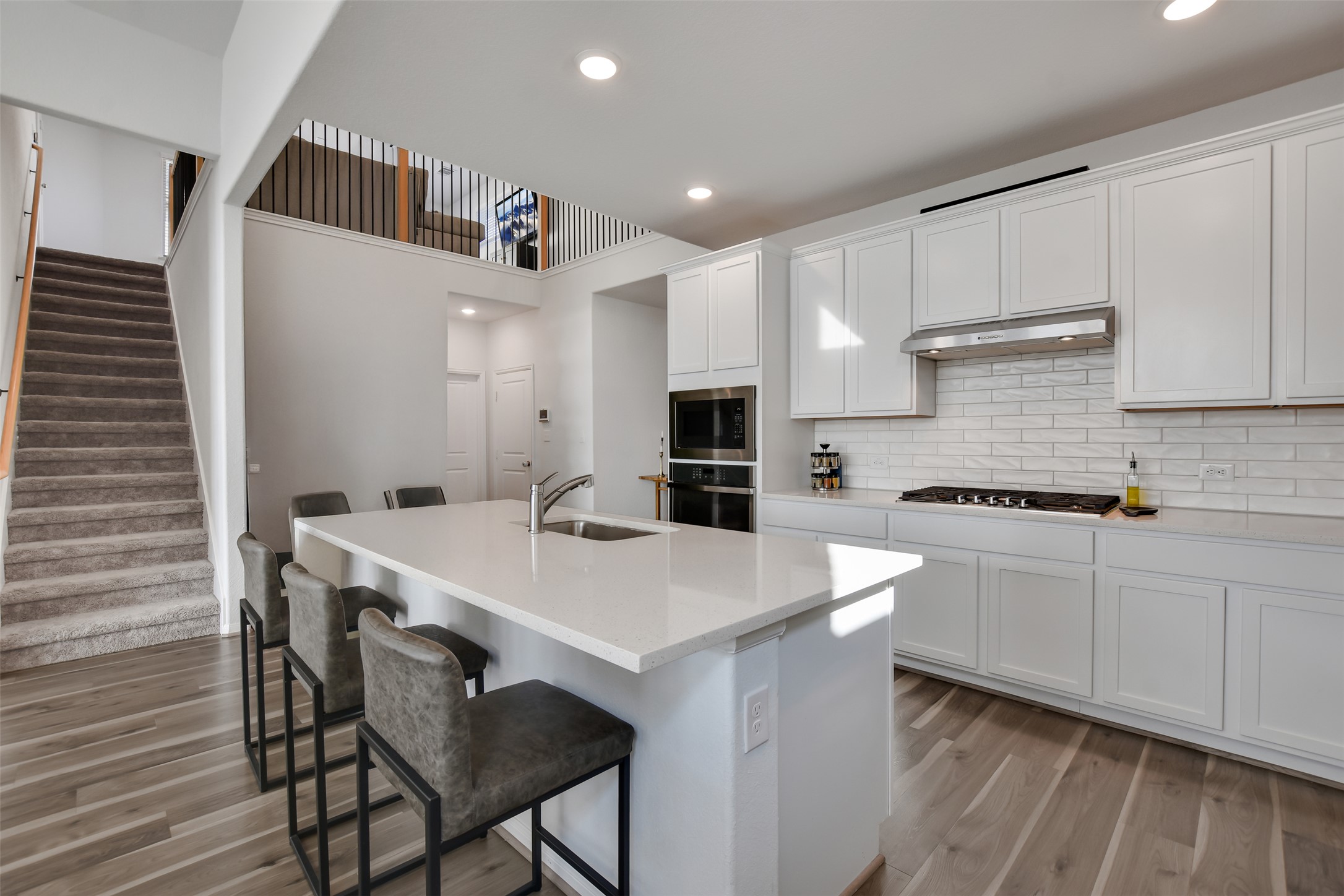 605 Oleander Loop Buda, TX 78610 - Photo 11 of 32 a kitchen with a table chairs refrigerator and microwave