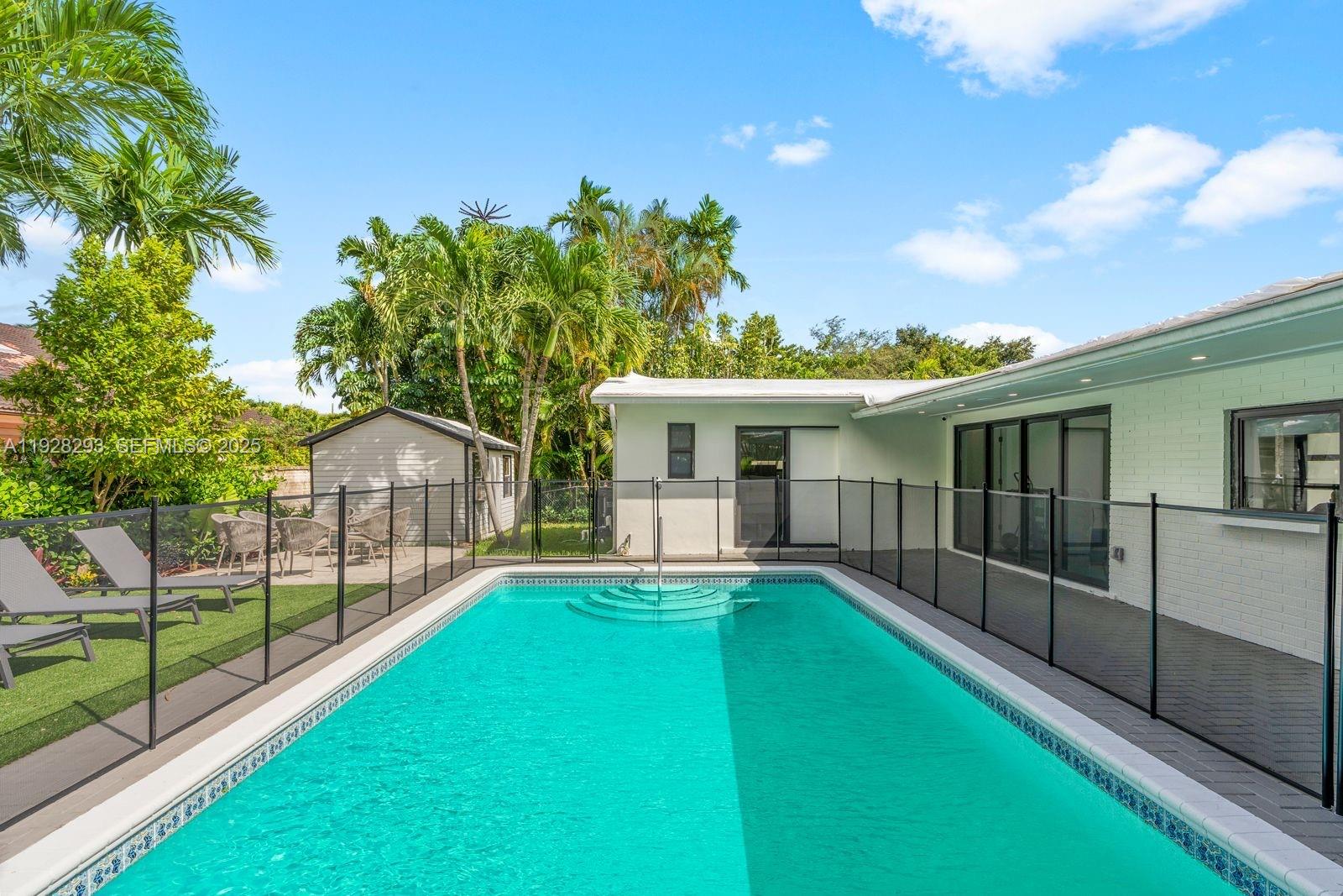 965 Northeast 171 Street Miami, FL 33162 - Photo 1 of 29 a view of a house with a yard and a patio