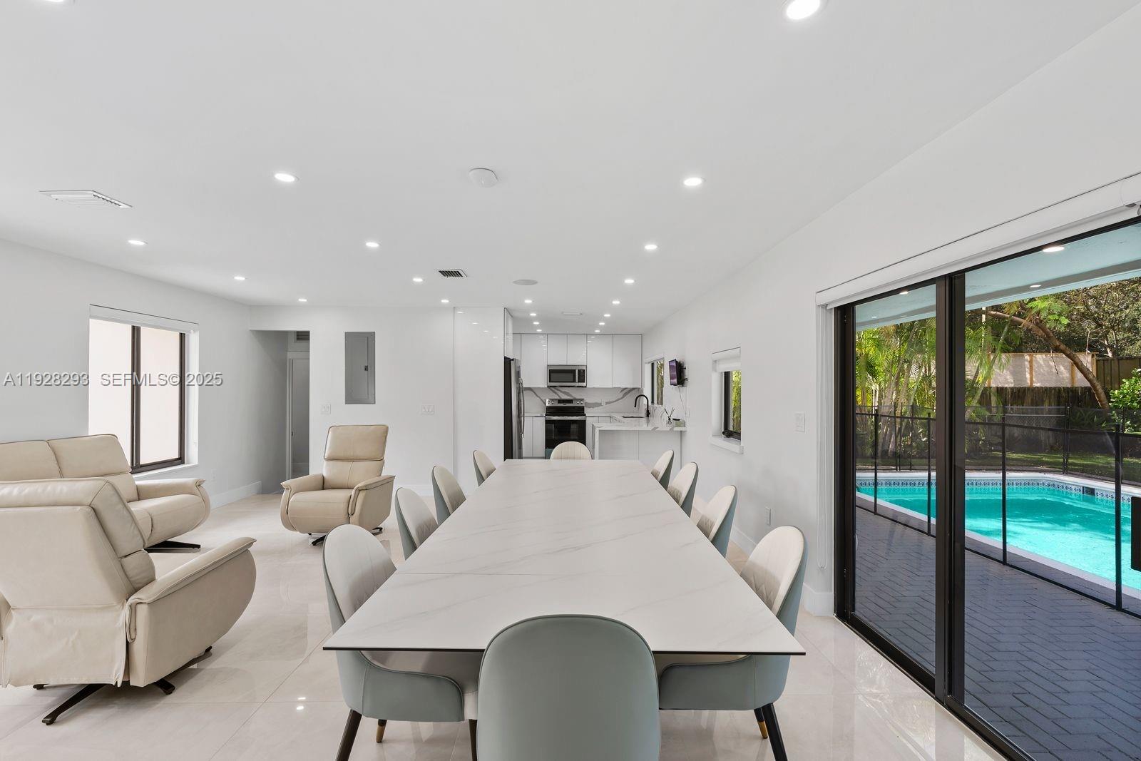 965 Northeast 171 Street Miami, FL 33162 - Photo 15 of 29 a living room with furniture and a table