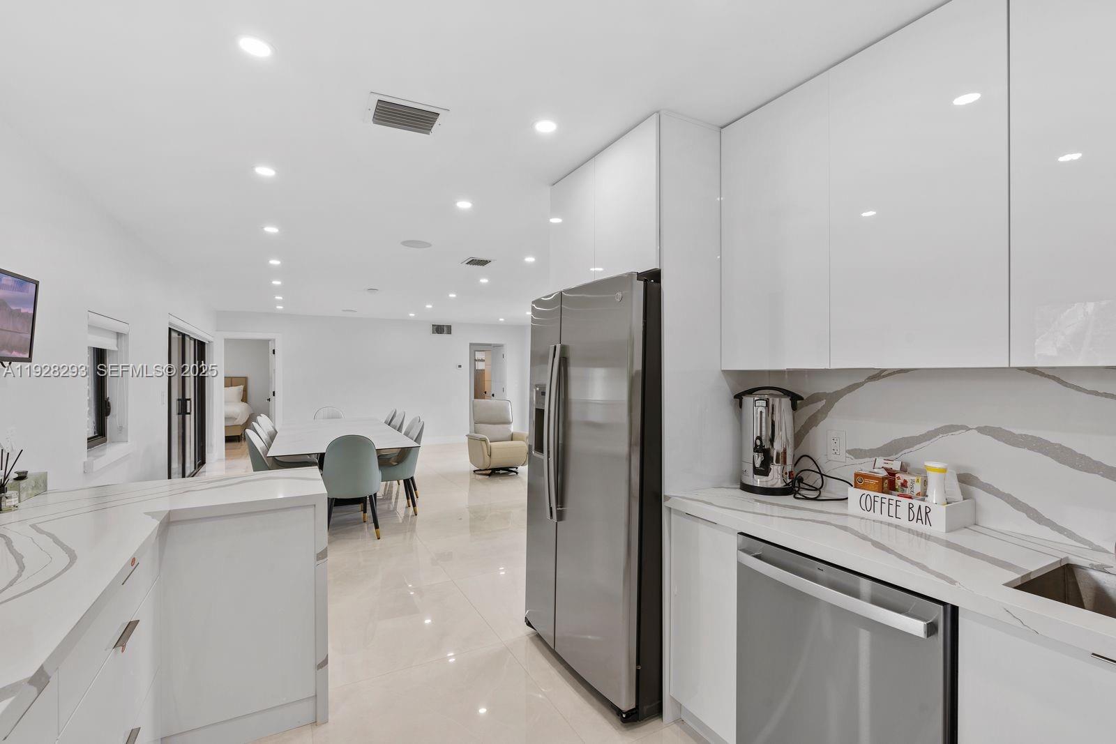 965 Northeast 171 Street Miami, FL 33162 - Photo 16 of 29 a kitchen with a refrigerator and a sink