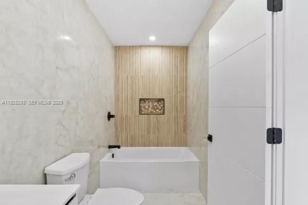 965 Northeast 171 Street Miami, FL 33162 - Photo 22 of 29 a bathroom with a toilet and a bathtub