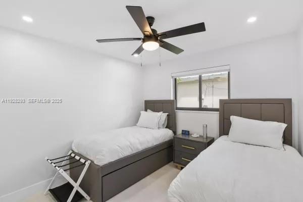 965 Northeast 171 Street Miami, FL 33162 - Photo 24 of 29 a bedroom with bed and window