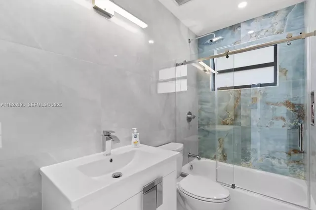 a large bedroom with a bed and a ceiling fan