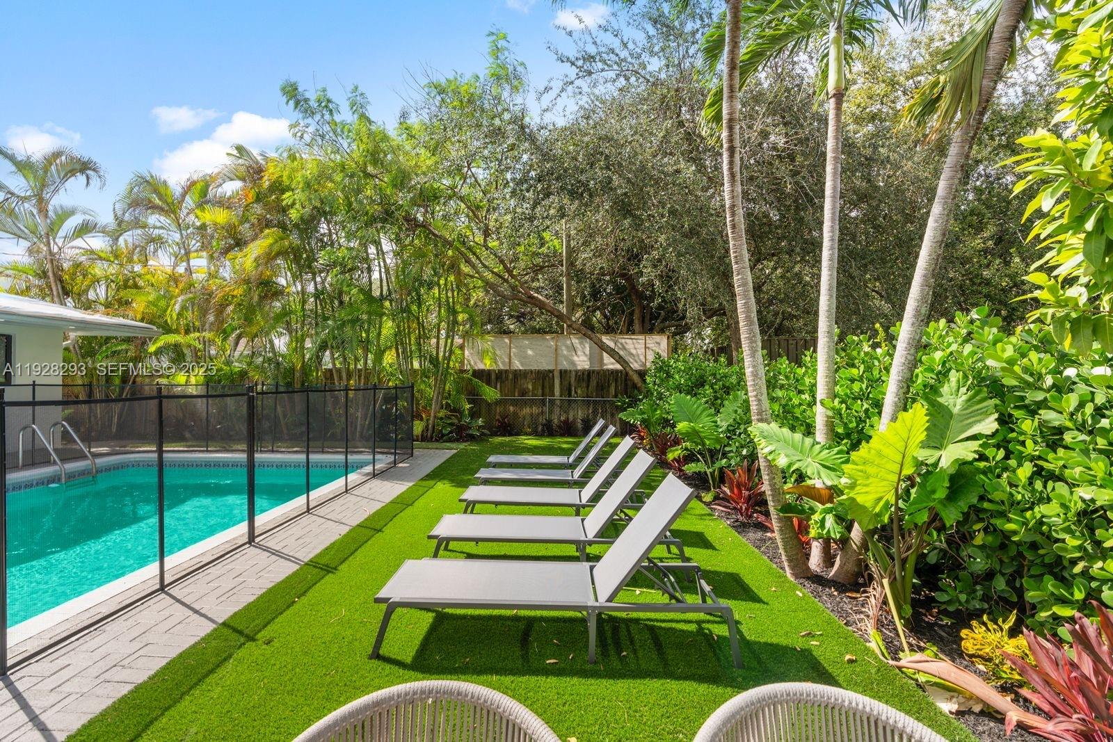 965 Northeast 171 Street Miami, FL 33162 - Photo 4 of 29 a view of a chair and table in the backyard