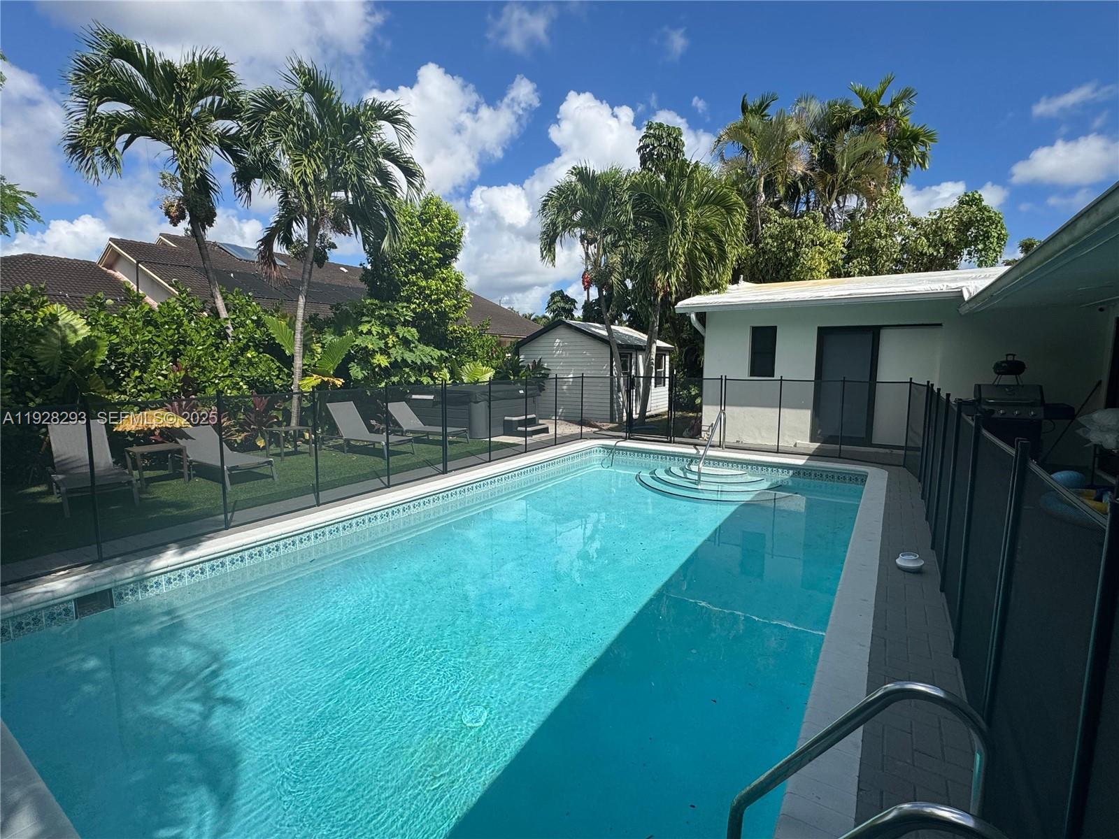 965 Northeast 171 Street Miami, FL 33162 - Photo 7 of 29 a view of a house with a backyard