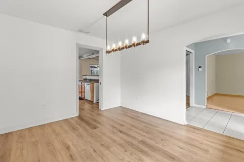 a kitchen with stainless steel appliances granite countertop a refrigerator a sink dishwasher a stove with wooden cabinets and floor