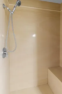 an empty room with a window and a ceiling fan