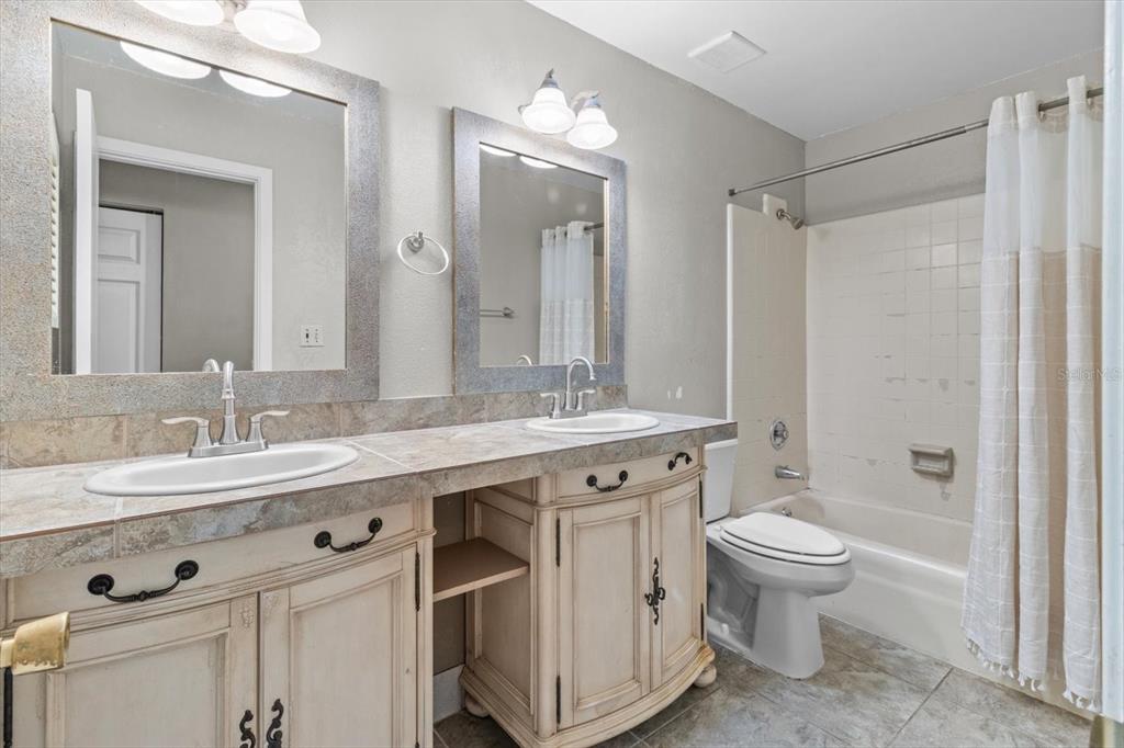 4015 Southeast 15th Street Ocala, FL 34471 - Photo 23 of 46 a bathroom with a double vanity sink mirror and toilet