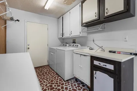 a view of an empty room with a window and a ceiling fan