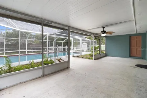 a view of a deck with a floor to ceiling window and wooden fence